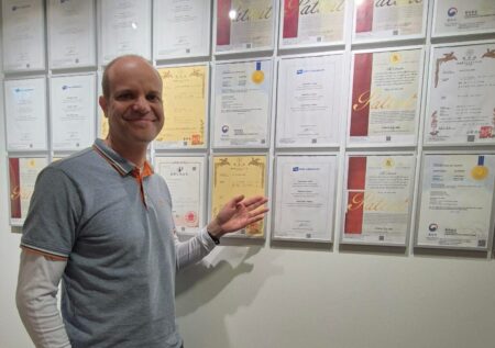 CTO Antti Jaakkola in front of the “patent wall” located in Kyocera Technologies office in Espoo, Finland, where the certificates of the granted patents are framed.